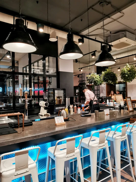 the modern bar has several stools lined up