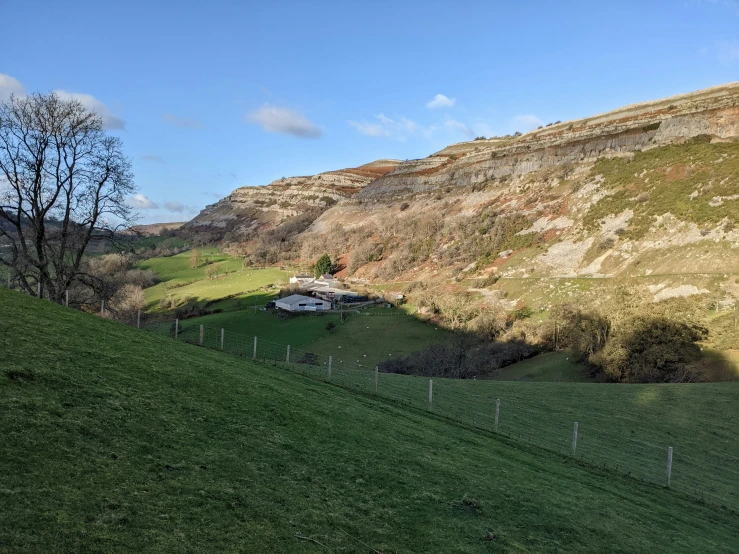 a green hillside covered in hills and grass