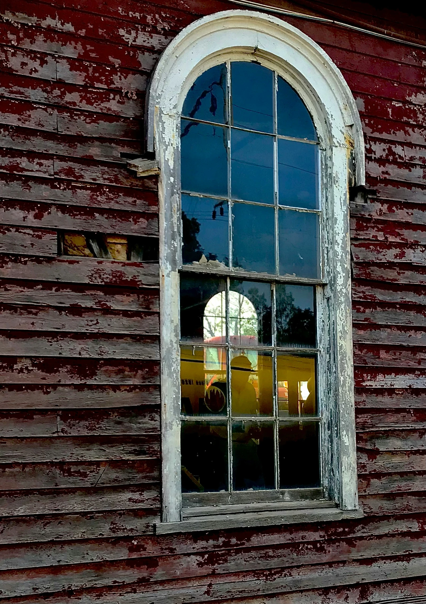 an old red building has an open window