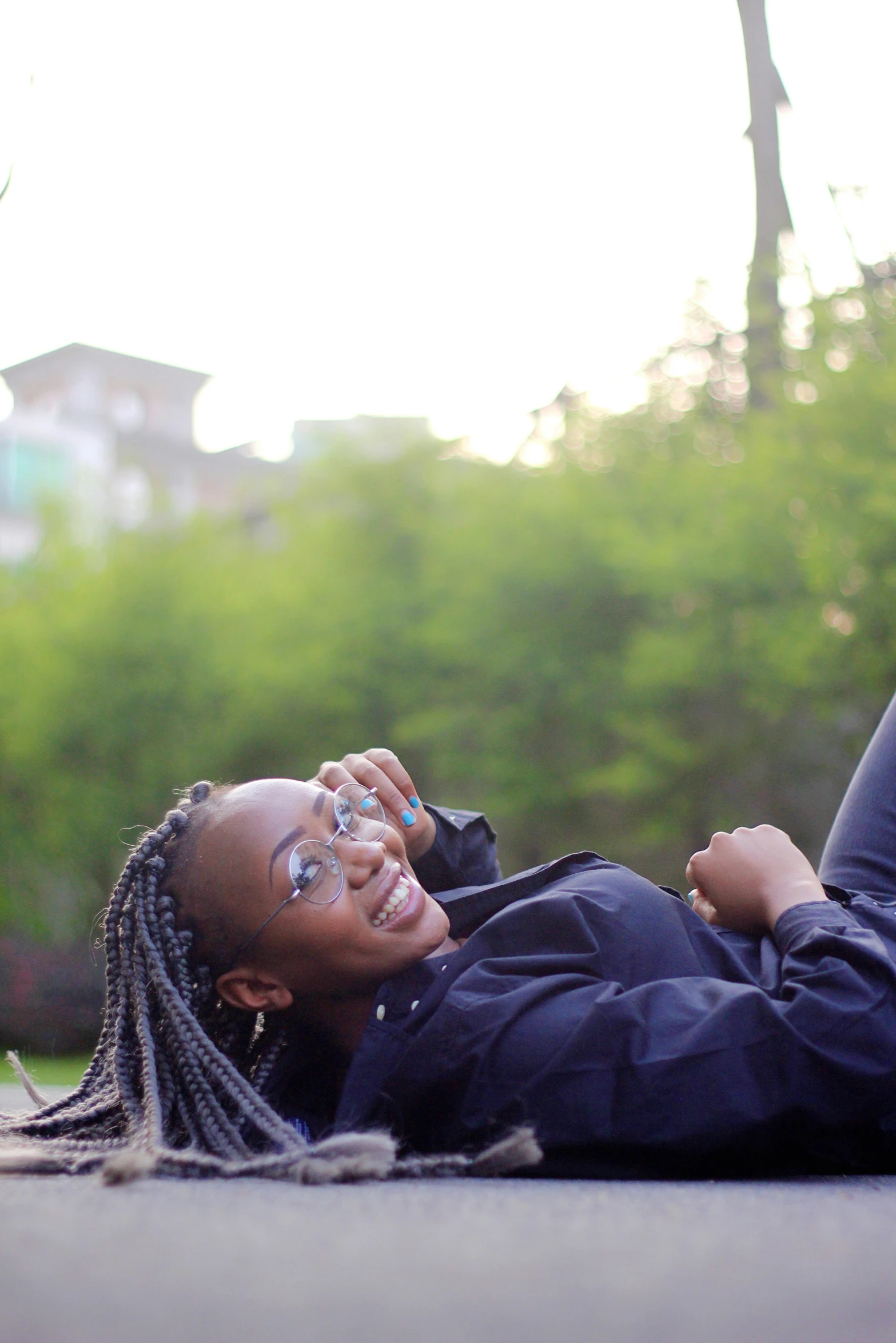 a woman laying on the ground using her cellphone