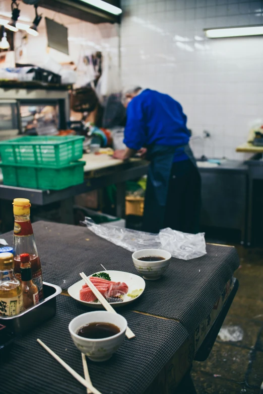 plates and bowls sit on a counter in a restaurant kitchen