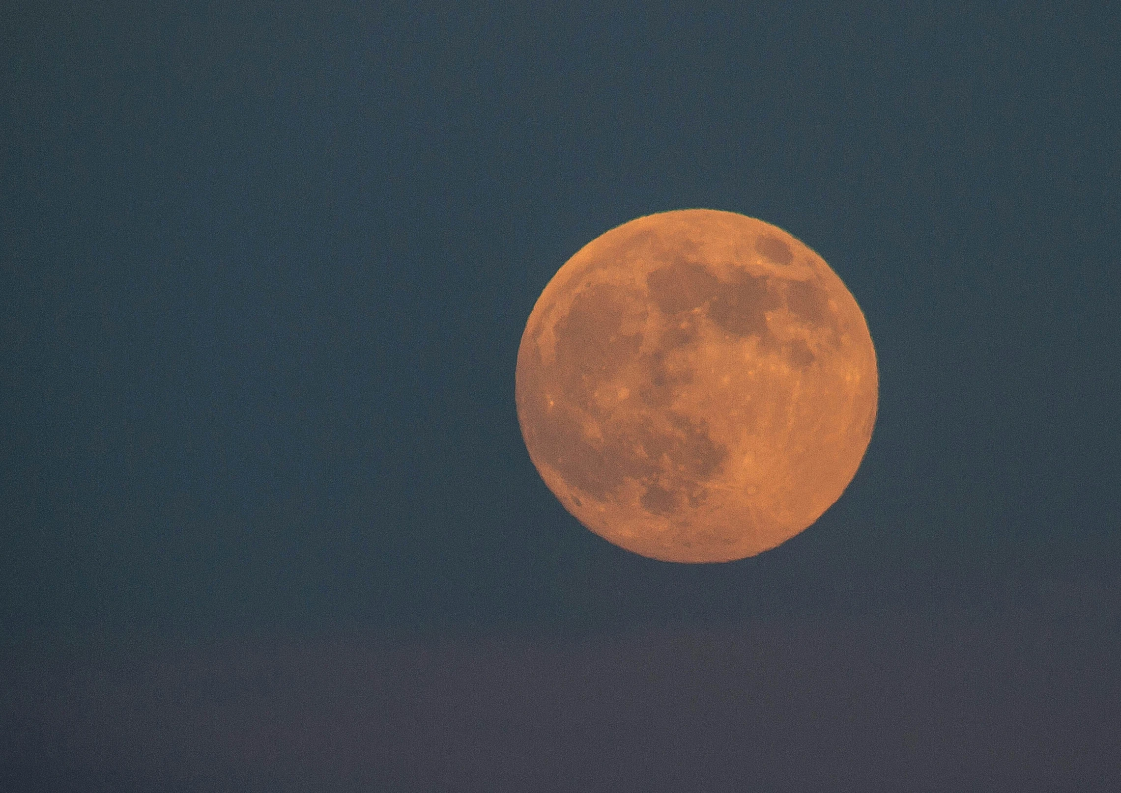 the moon that is very large, bright and orange