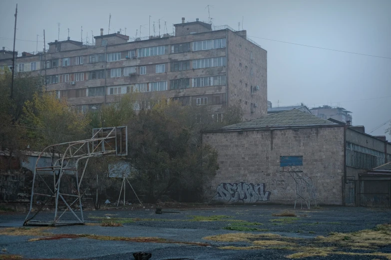a basketball court next to a building with graffiti
