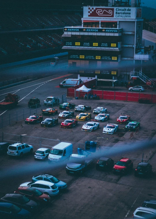 many cars are parked near each other in front of an auto shop