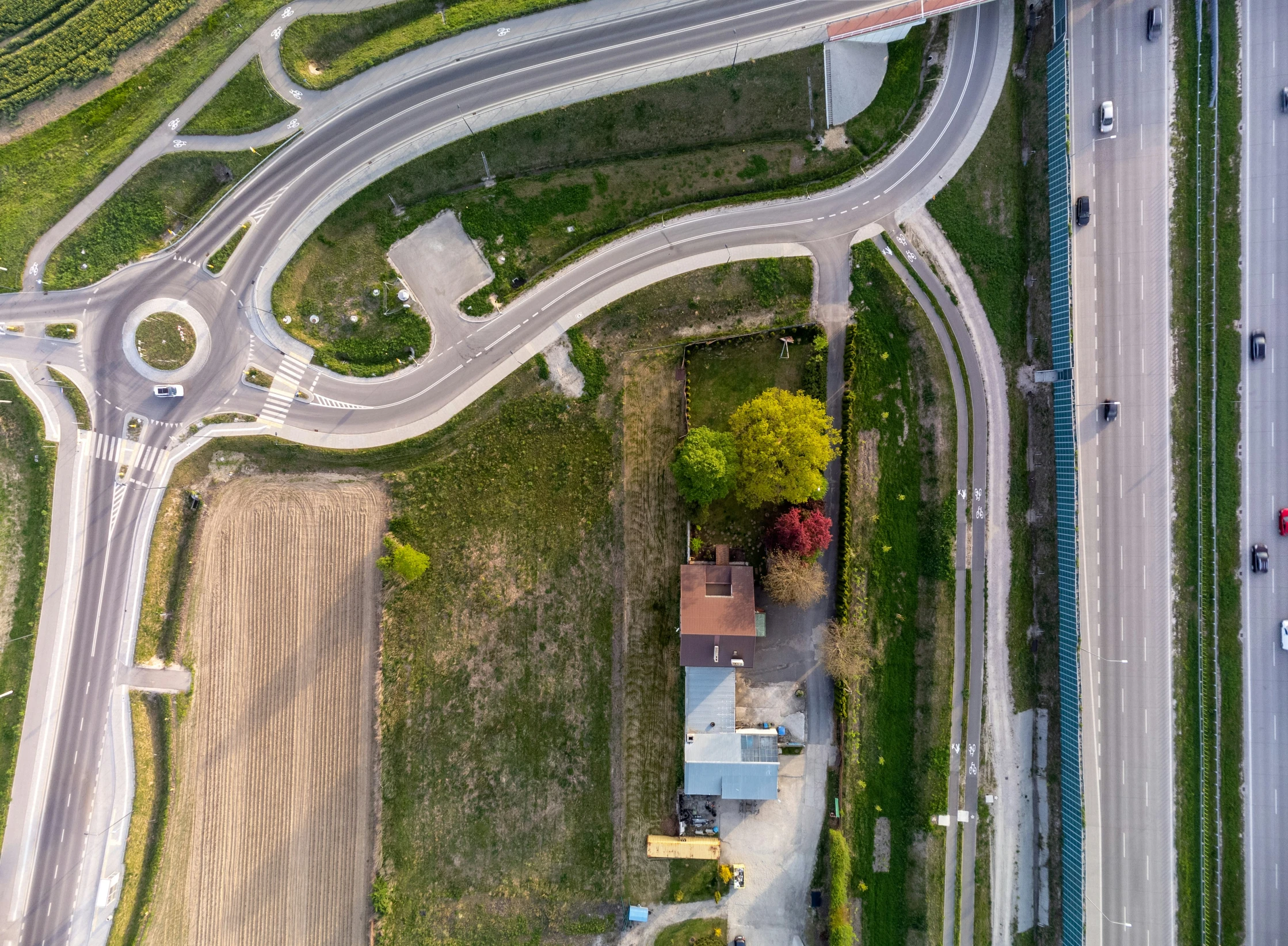 an overhead view of the top half of a country road