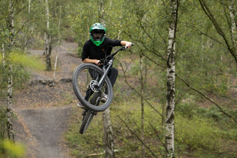 a person doing a trick on their mountain bike