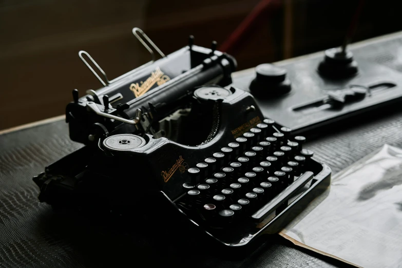 a black typewriter sitting on top of a table