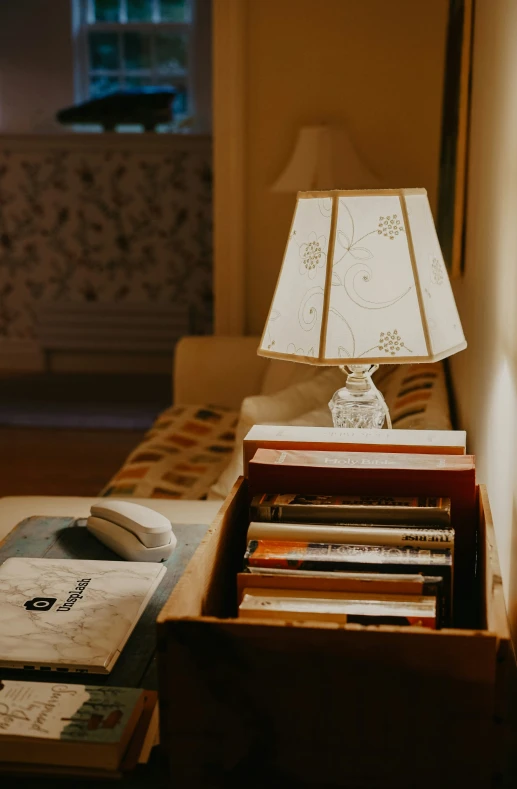 a table filled with books and a lamp