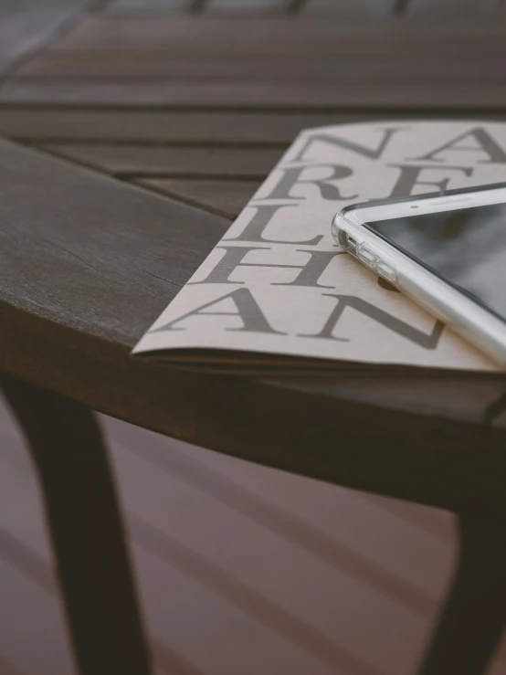 the table has a tablet and a magazine on it