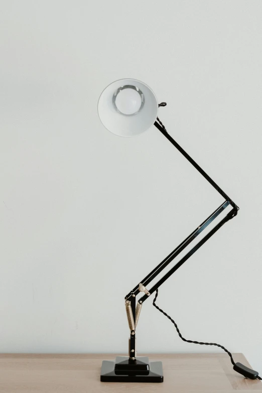 the metal table lamp is very small and is plugged into the wall