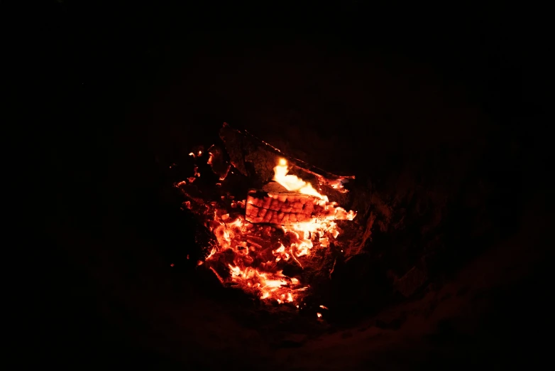 a fire burning in the dark, with bright orange light