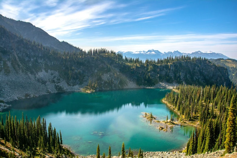 this lake is surrounded by mountains and pines