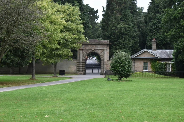 a brick building with two archways and a clock tower