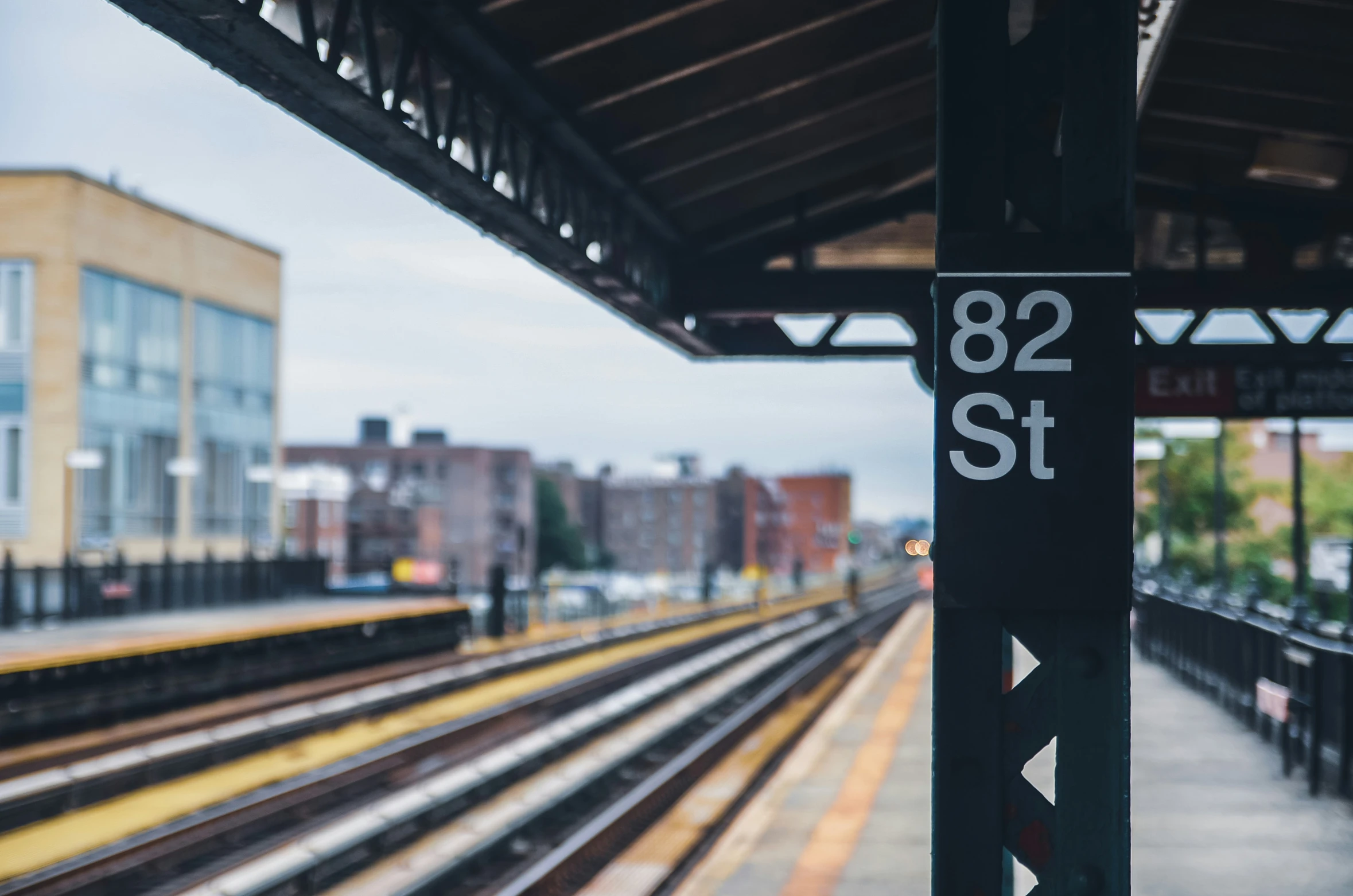 a train station with railroad tracks on both sides of it