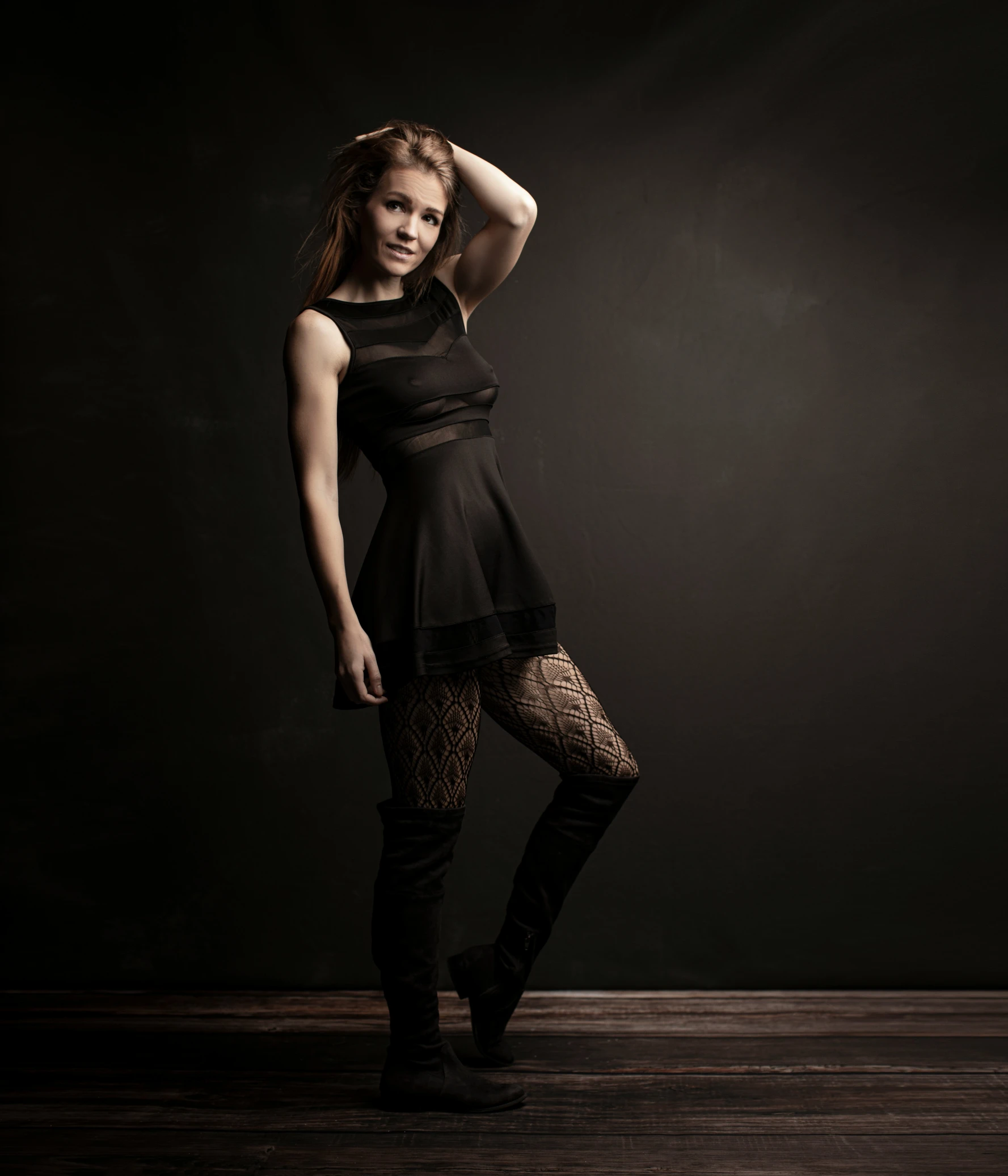 a beautiful young woman posing in a black dress