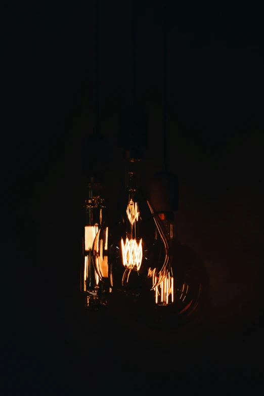 several lighted candles sitting on a black table