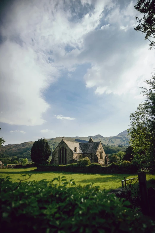 a church surrounded by lush green trees in the countryside