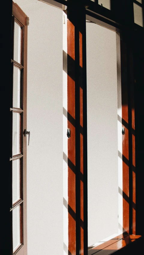 a close up of a closed door with light coming in through the open window