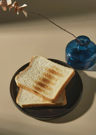 a piece of bread is placed on a plate with a flower