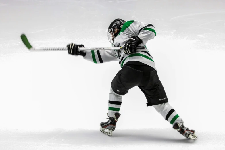 a man wearing hockey gear holding a hockey stick