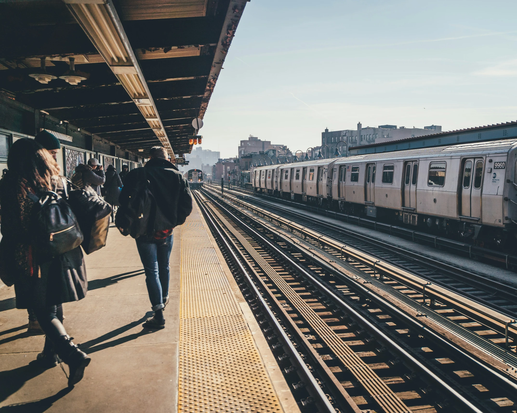 a group of people standing near a train