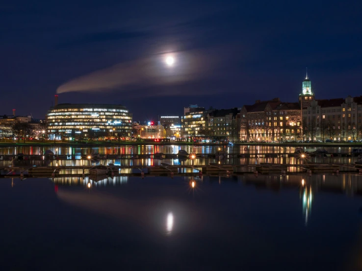 a city lit up at night from across a river