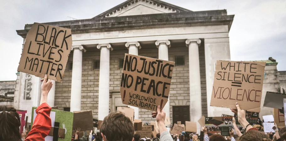 some protesters are protesting on the front lawn of a large building