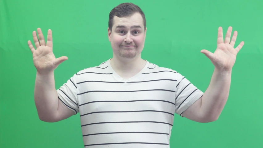 a man in white shirt holding up his hands