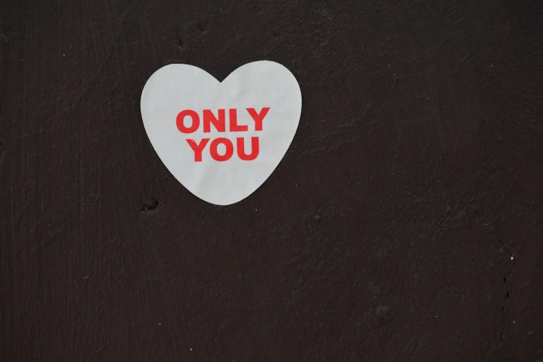 a white heart sticker with an only you message