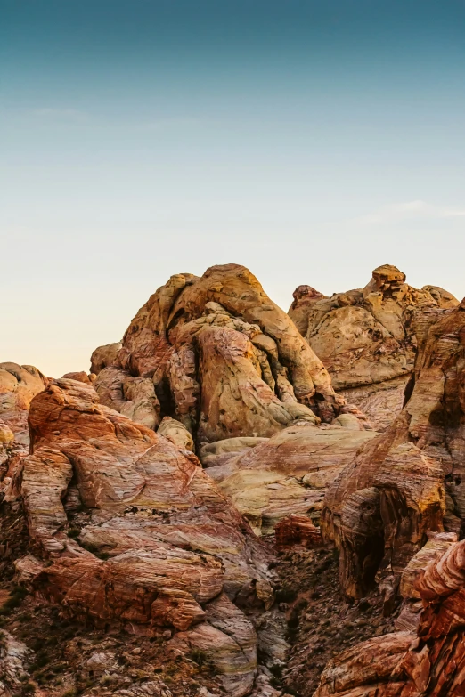 rocks at the foot of a hill under a blue sky