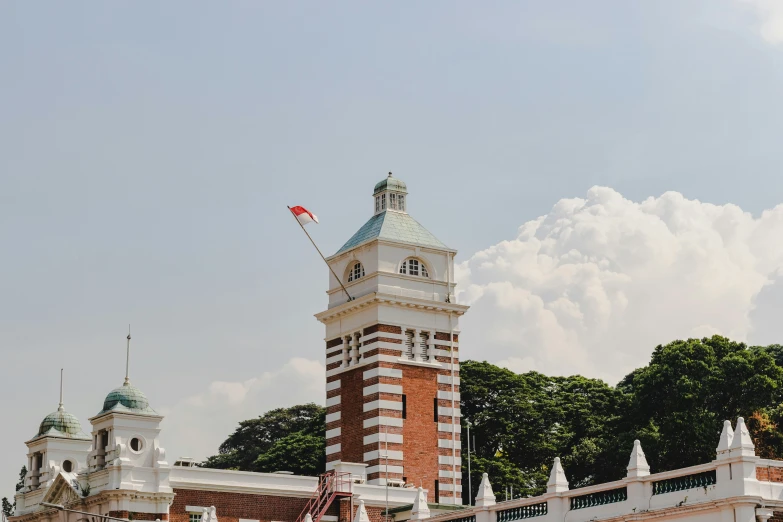 an old - fashioned clock tower stands at the base of another tall building