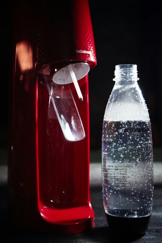 a closeup s of an open water bottle next to a plastic water bottle