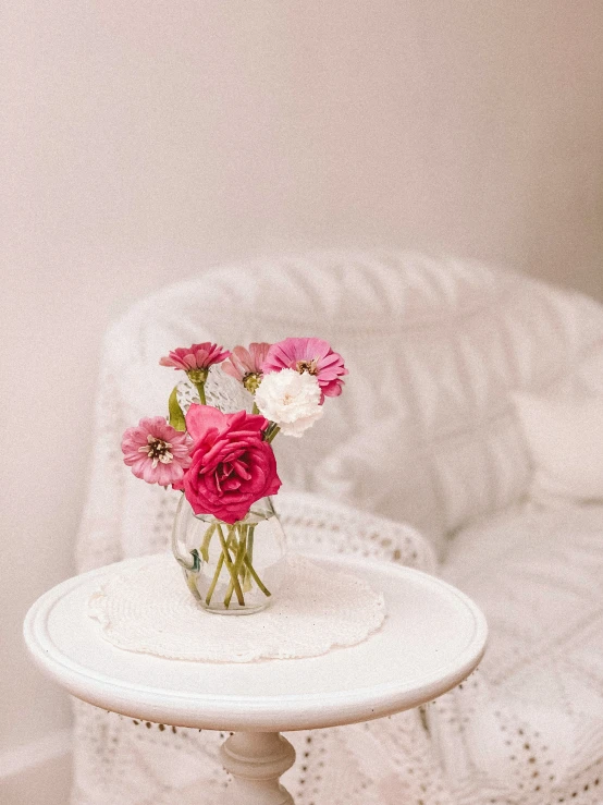 flowers in a vase are displayed on a table