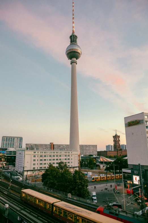 a view of a very tall tower near a train station