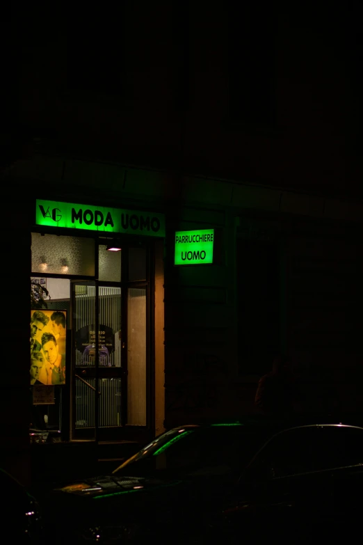 neon green lights adorn the front of an art gallery
