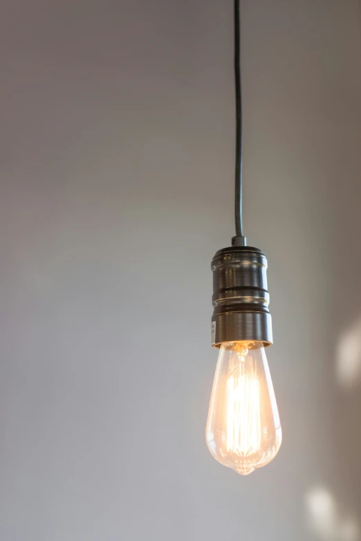 a light bulb hanging from the ceiling on a wall