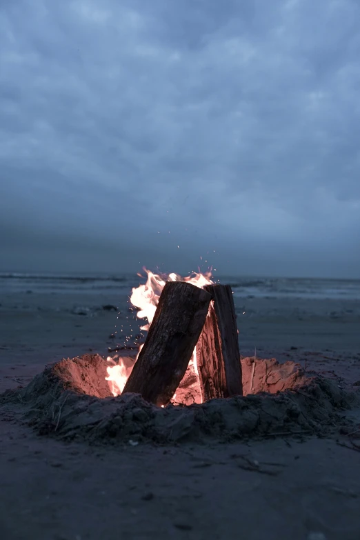 an open campfire with some very big wood