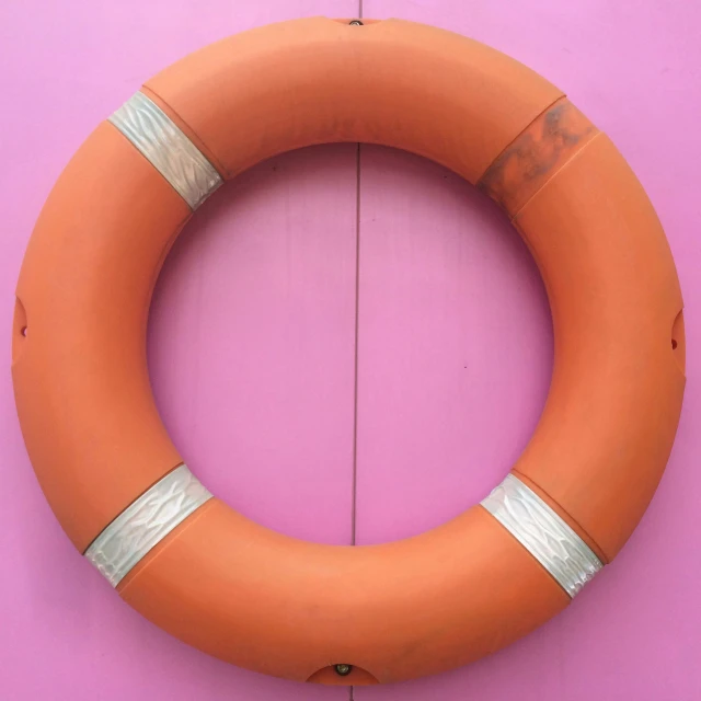 an orange life preserver attached to a purple wall