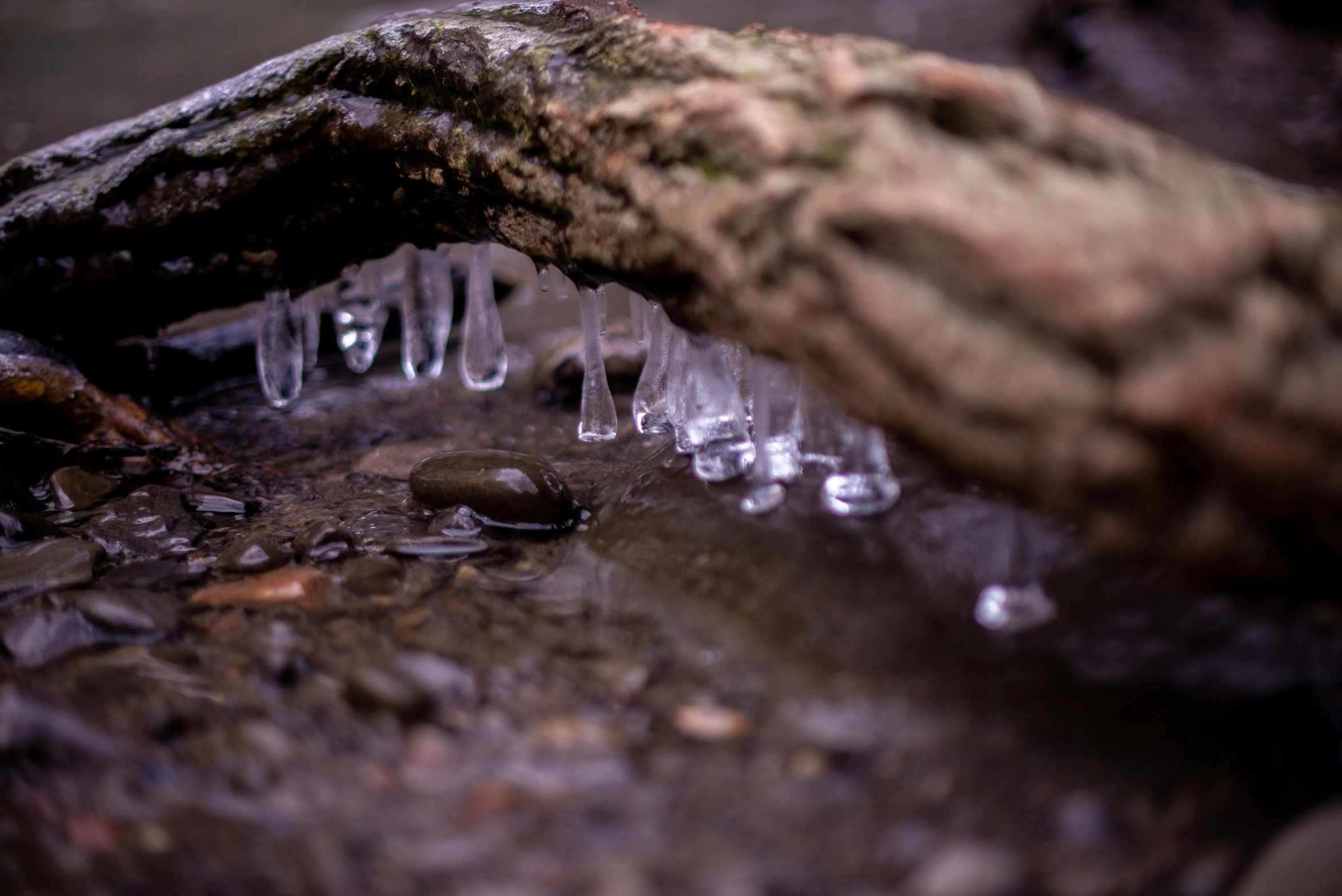 a small waterfall has ice on top