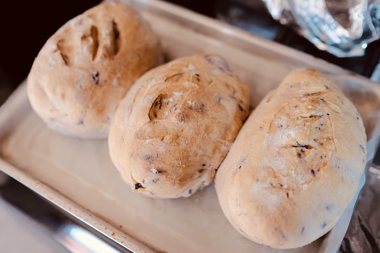 three loaves of bread on a tray