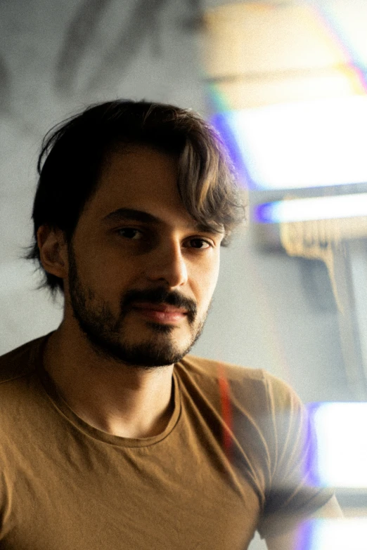 a man with long hair looking directly at the camera