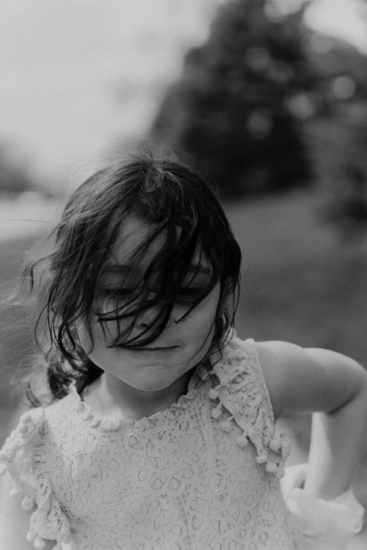 a girl with a jacket standing in the grass