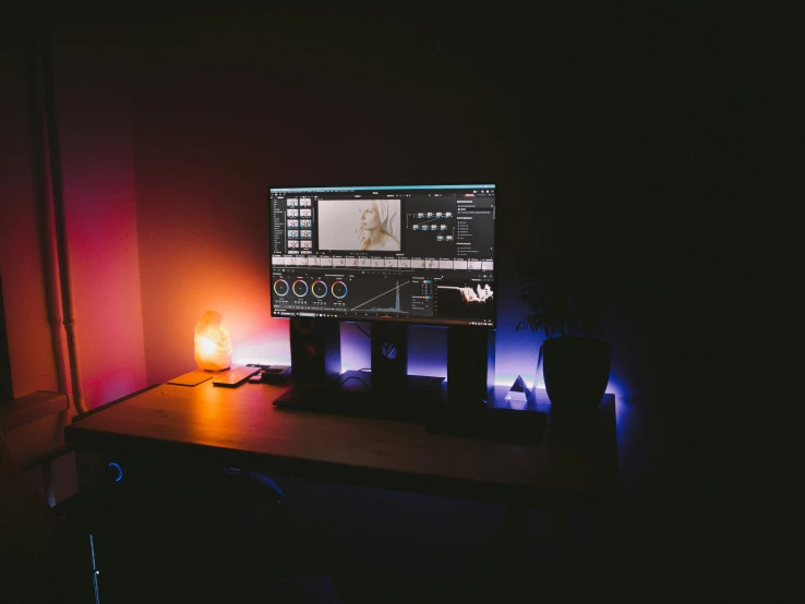 a computer monitor screen illuminated by colorful light