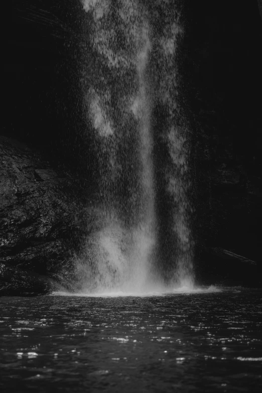 the water is spraying from a jet in the pond