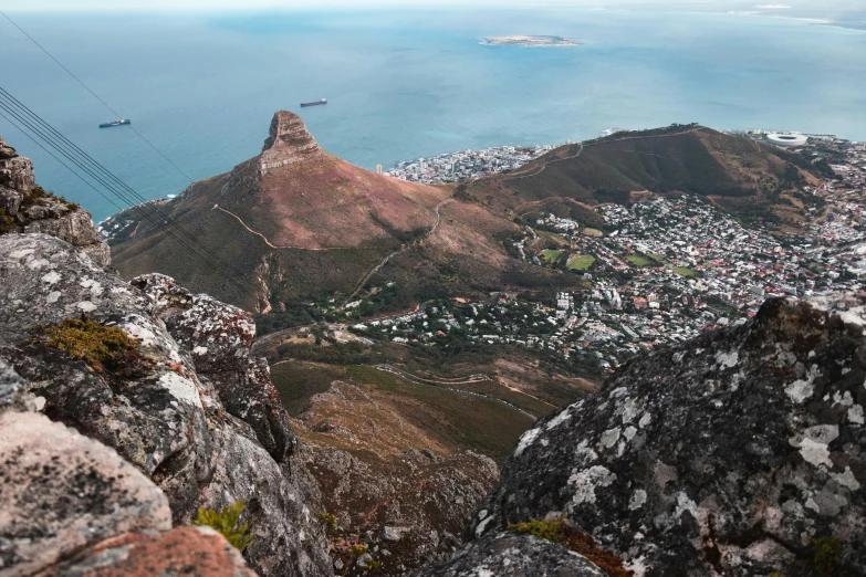 the view over a city sits at the base of a high mountain