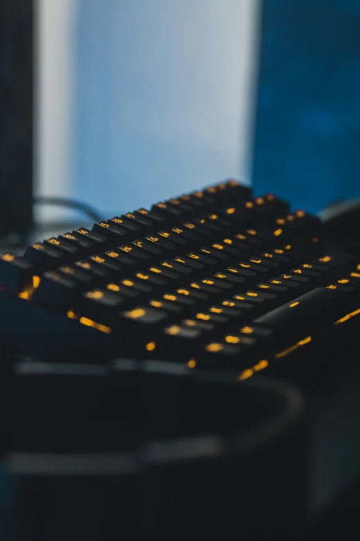 a keyboard with yellow glowing letters on it