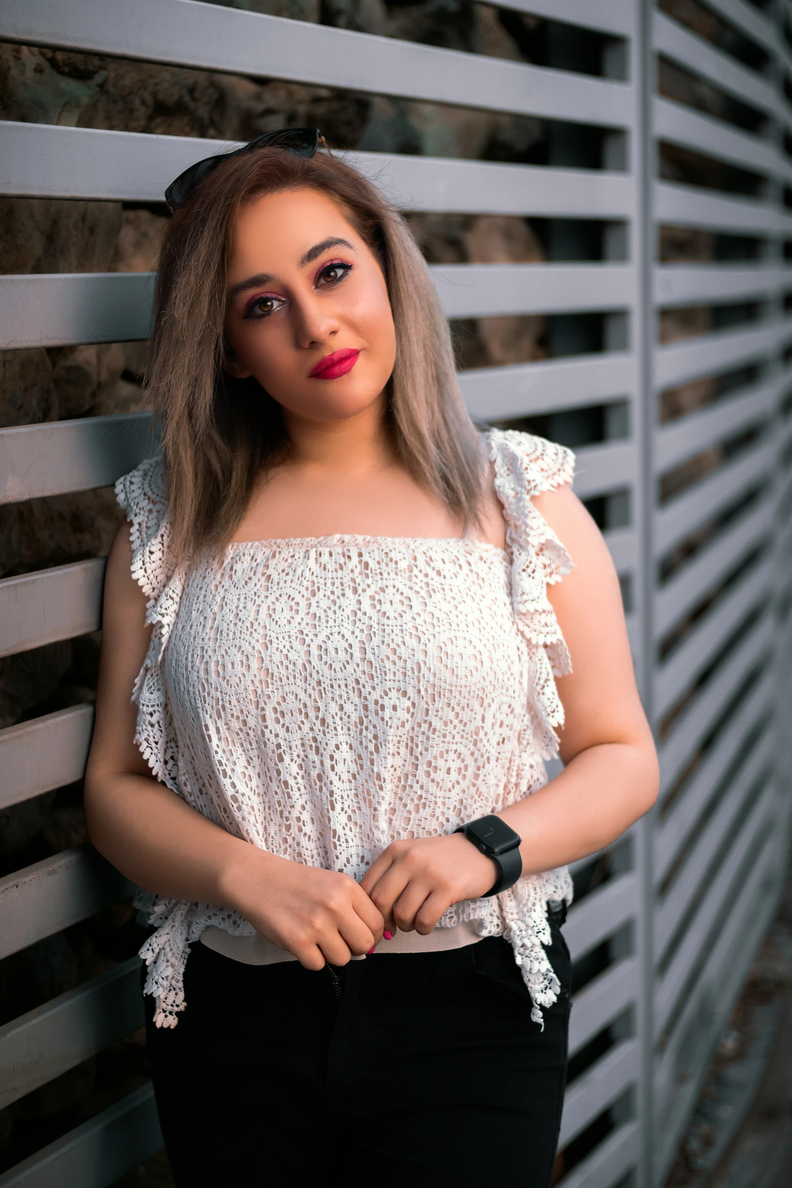 a woman posing for the camera in a white top