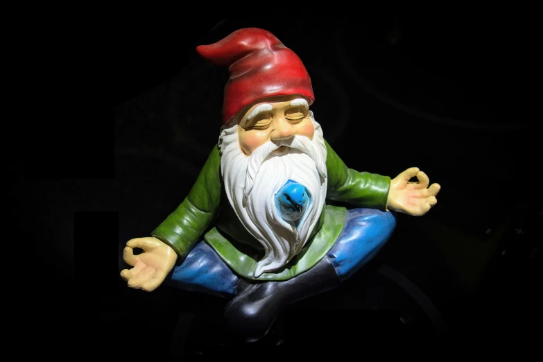 a statue of a gnome sitting in the middle of his body