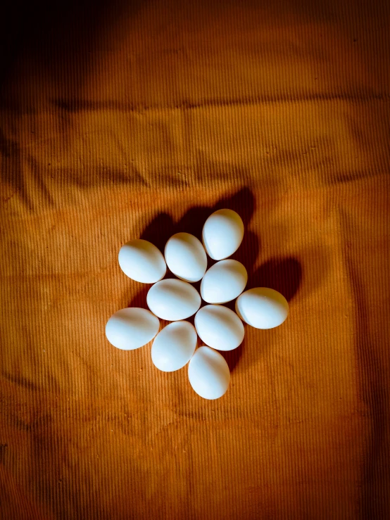 white eggs are arranged on a wooden table