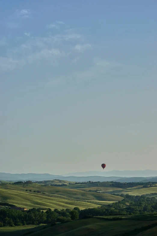 the view from atop of a distant, hilly area